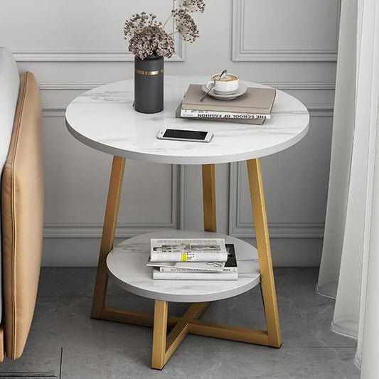 Round side table with marble top and wooden legs in a room setting.