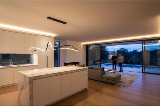 Modern kitchen with marble island and living room in the background