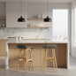 A modern kitchen island with a white marble countertop and light wood cabinetry, paired with two bar stools featuring gray upholstered seats and natural wood legs. The space is styled with black pendant lights, open wood shelves, and a marble backsplash.