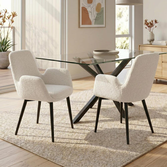 Dining room with a glass table and two upholstered chairs on a textured rug.