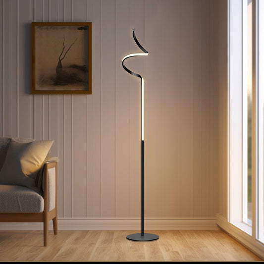 Modern floor lamp in a room with a couch and framed picture on the wall.