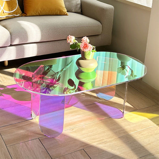 Colorful glass coffee table with floral arrangement in a living room setting