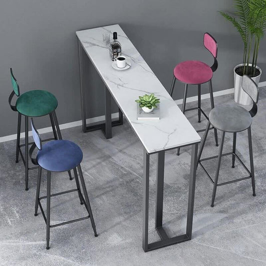 Bar height table with marble-like surface and colorful stools in a room setting.