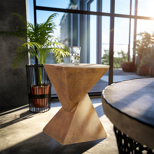 Wooden side table with a glass of water on a patio with plants and a view of buildings.