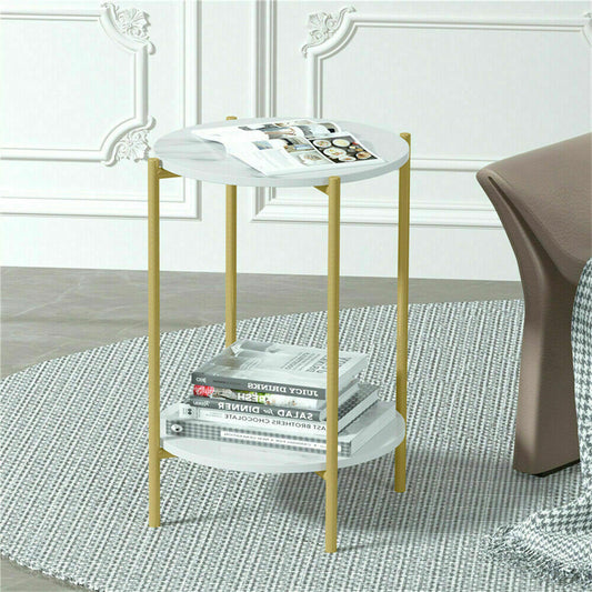 Small round side table with gold legs and white top in a room setting.
