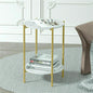 Small round side table with gold legs and white top in a room setting.