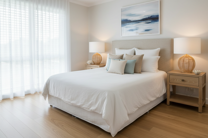 Neatly made bed in a bedroom with bedside lamps KK Lifestyle